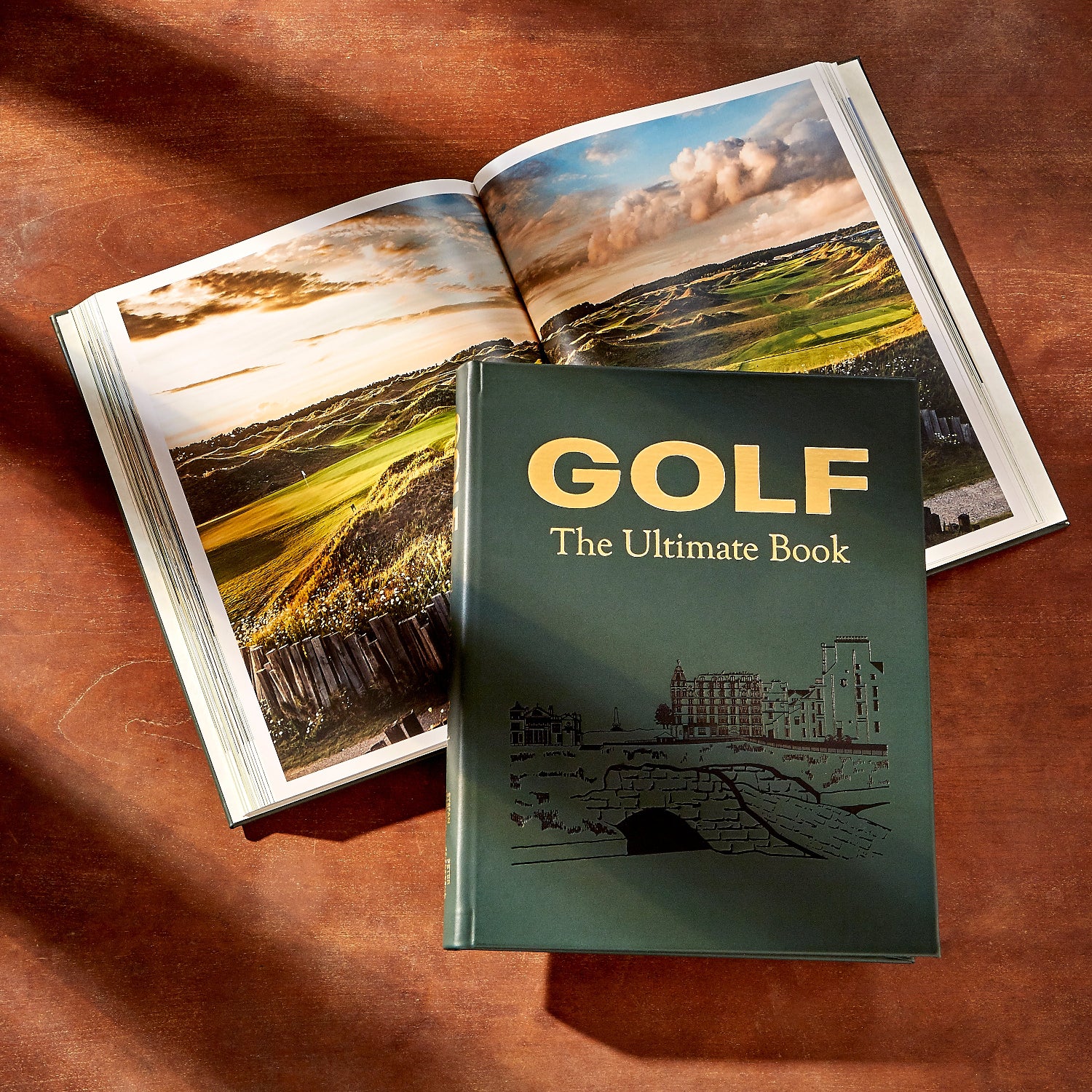Golf: The Ultimate Book on wood table