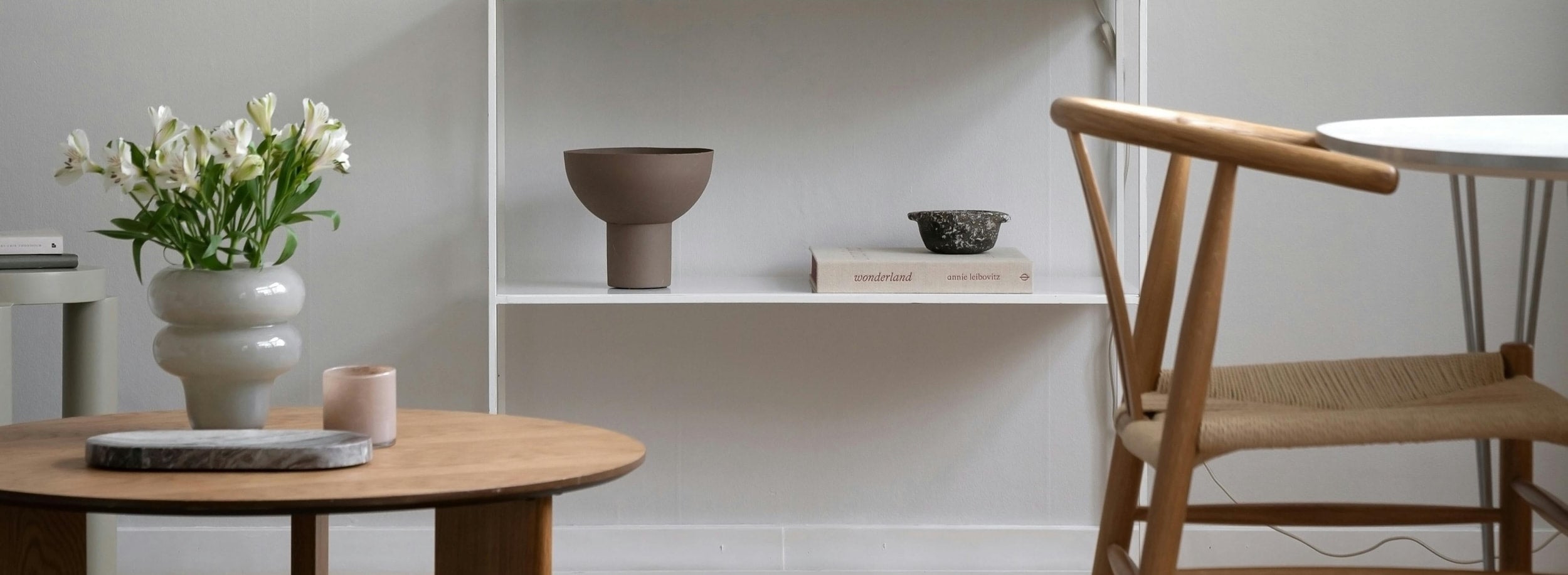 Modern living room coffee table, bookshelf, and small dining table and chair