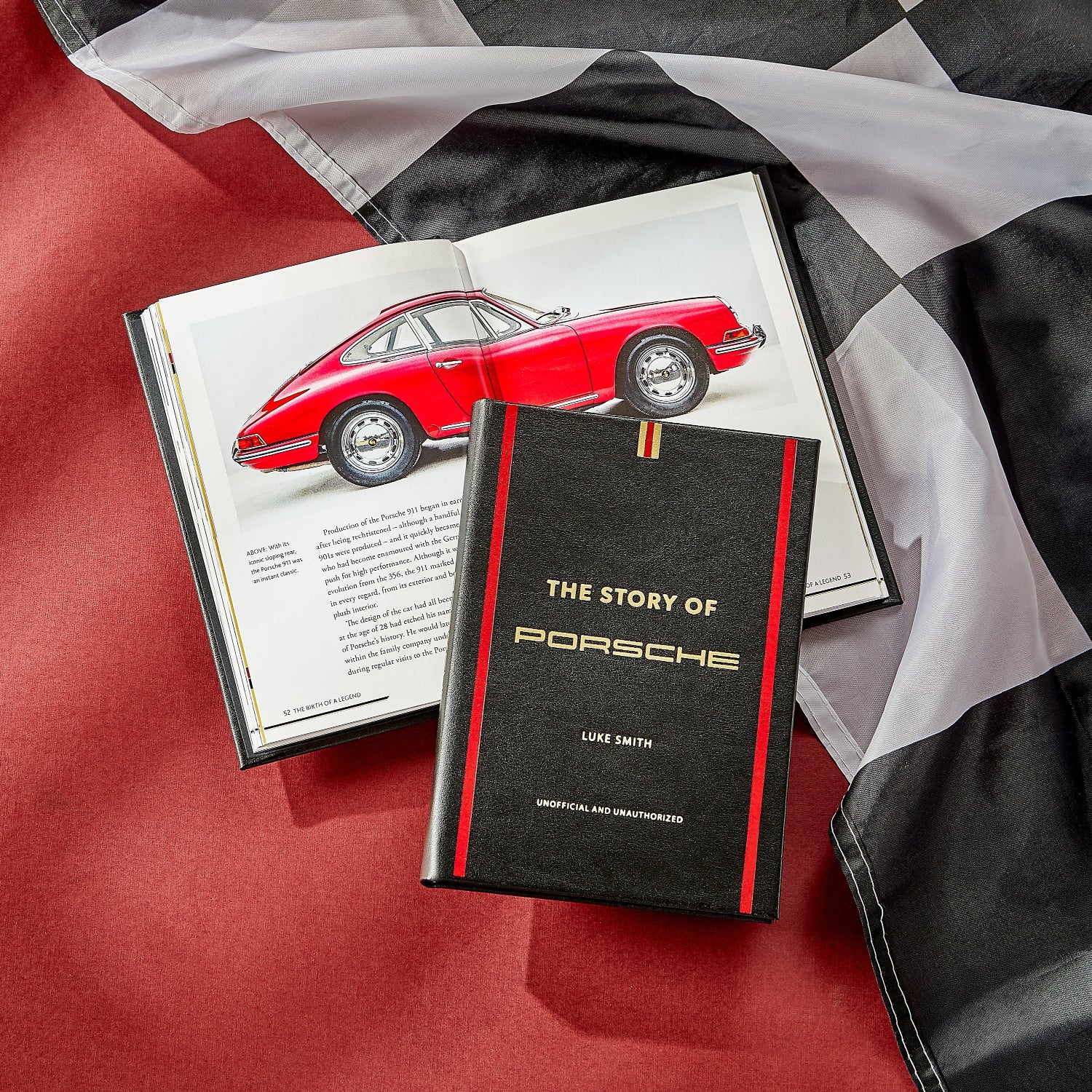 The Story of Porsche book laid on a checkered flag