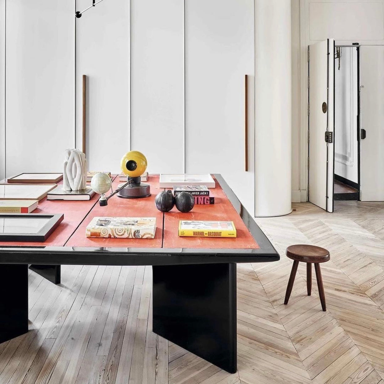 Large modern table with decor items in a stylish room.