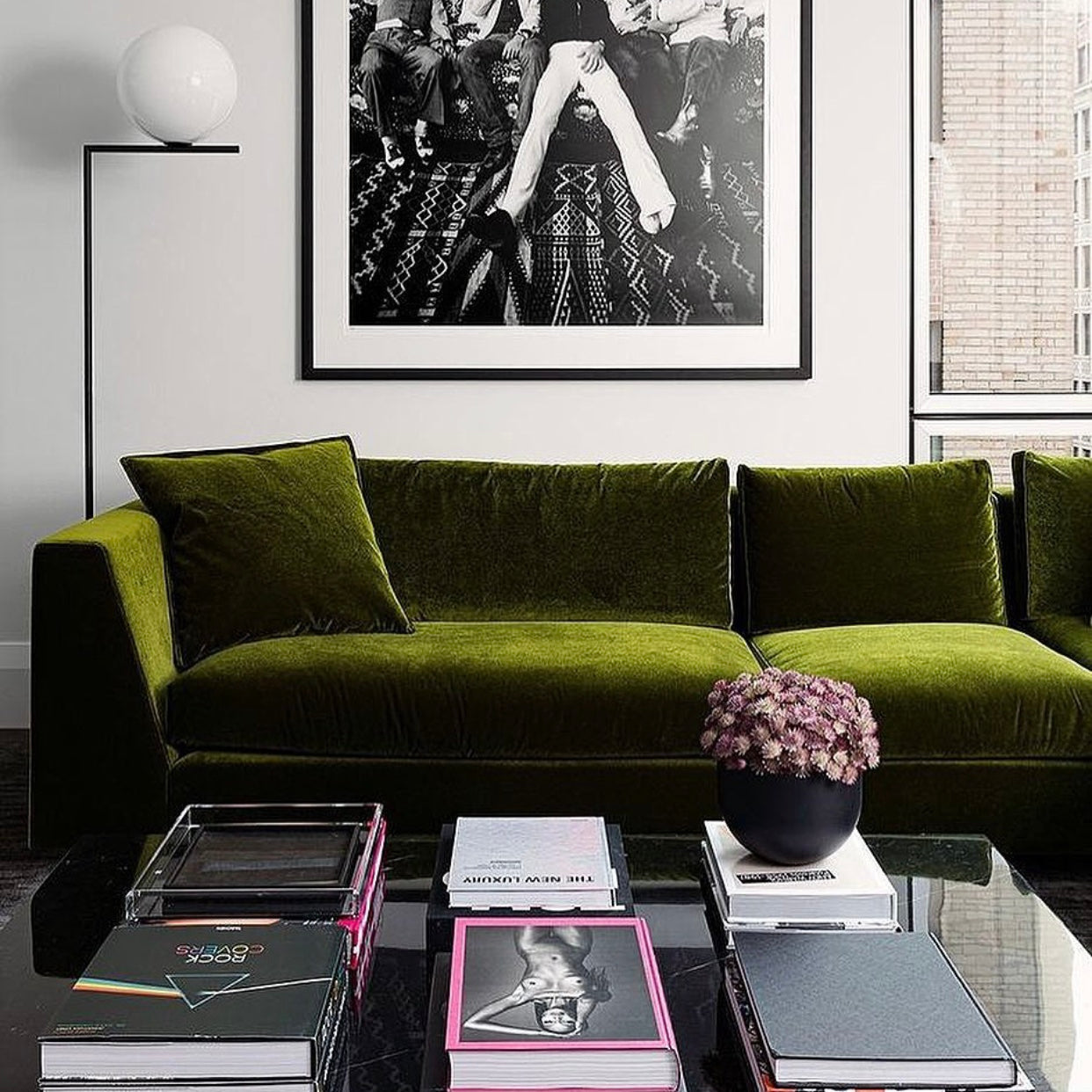 Green couch pink black coffee table books