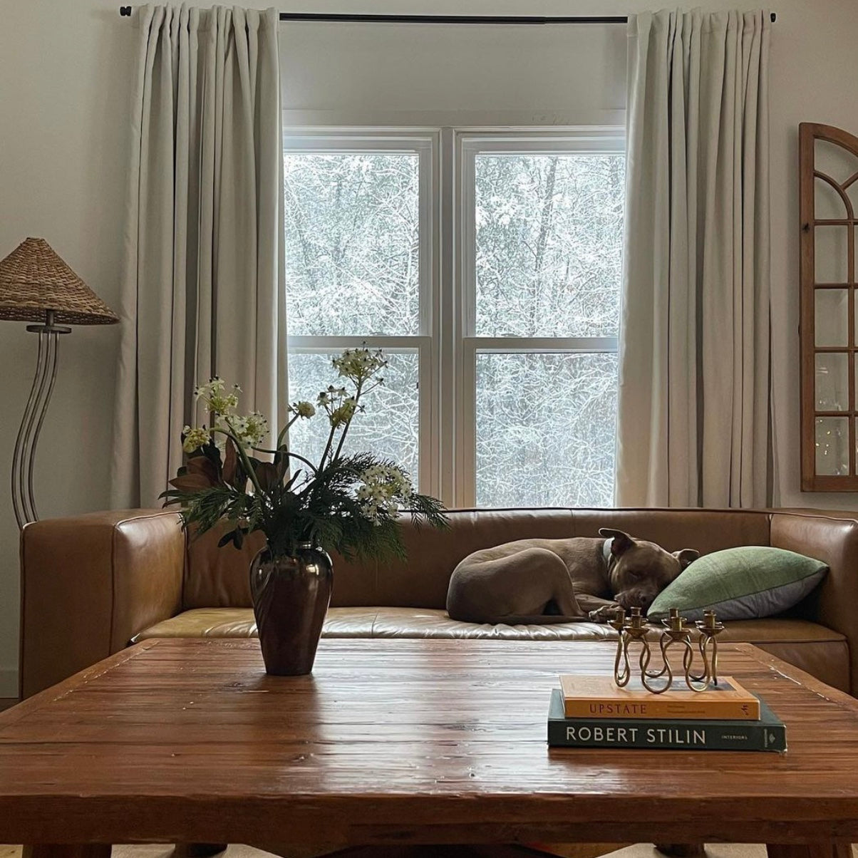 Leather and wood living room with orange and green coffee table books