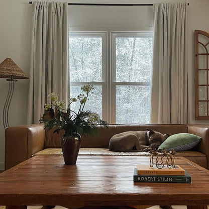 Leather and wood living room with orange and green coffee table books